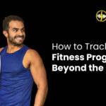 Man smiling while holding a weighing scale – tracking fitness progress